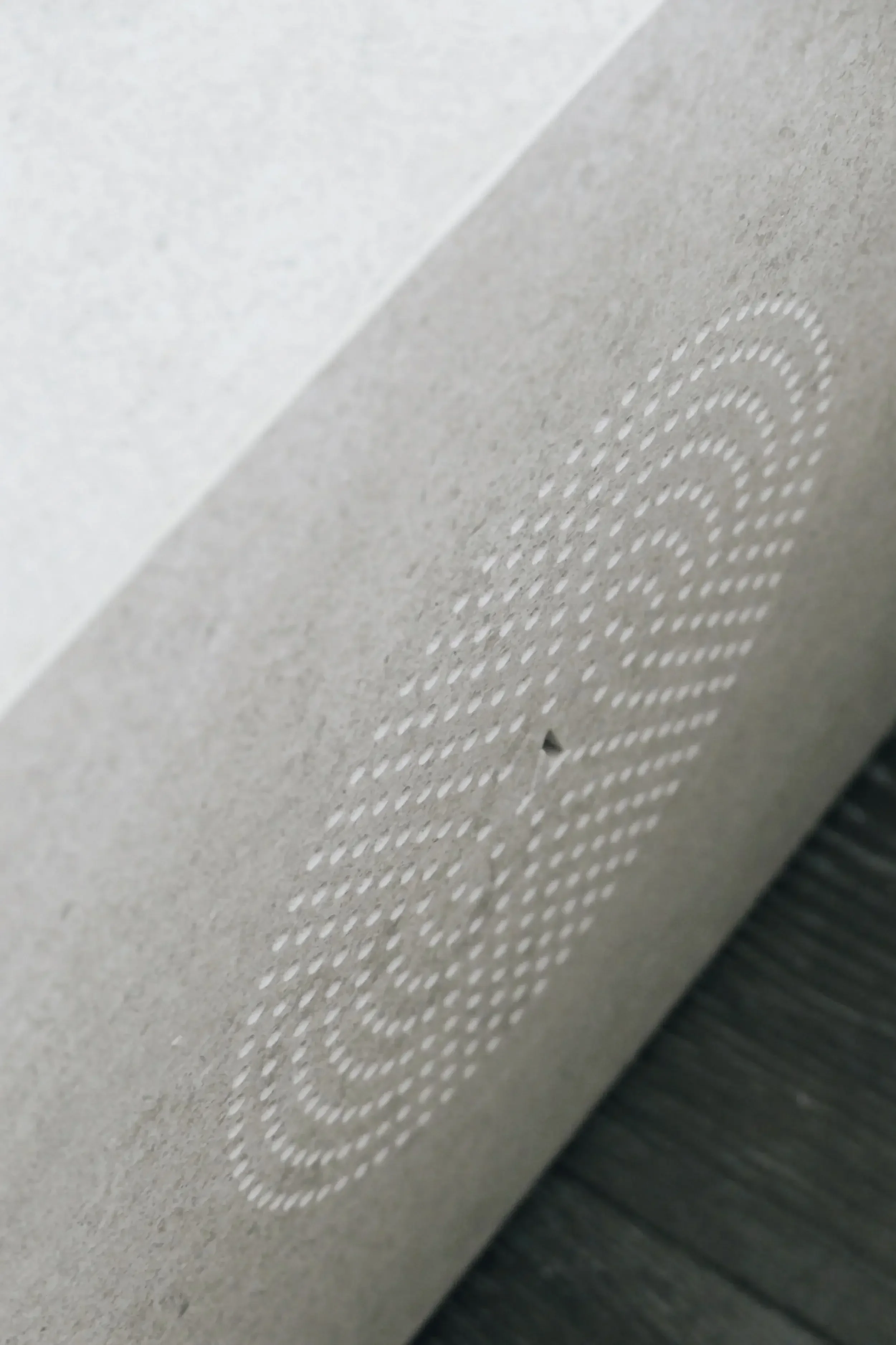 Detail of high-end Italian porcelain tile with custom CNC-cut textures, showcasing luxury surface design in a Dorset interior renovation.