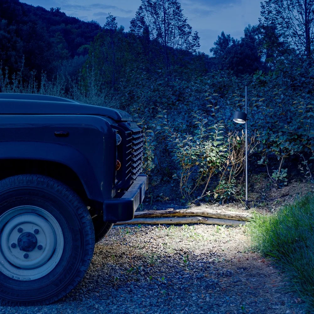 Davide Groppi Bubka Bollard outdoor floor lamp featuring an adjustable metal spotlight, AISI 316L stainless steel body, LED technology with 2700K or 3000K light, IP65 rated, supplied by Abitalia South Coast in Dorset, Hampshire, and Surrey.