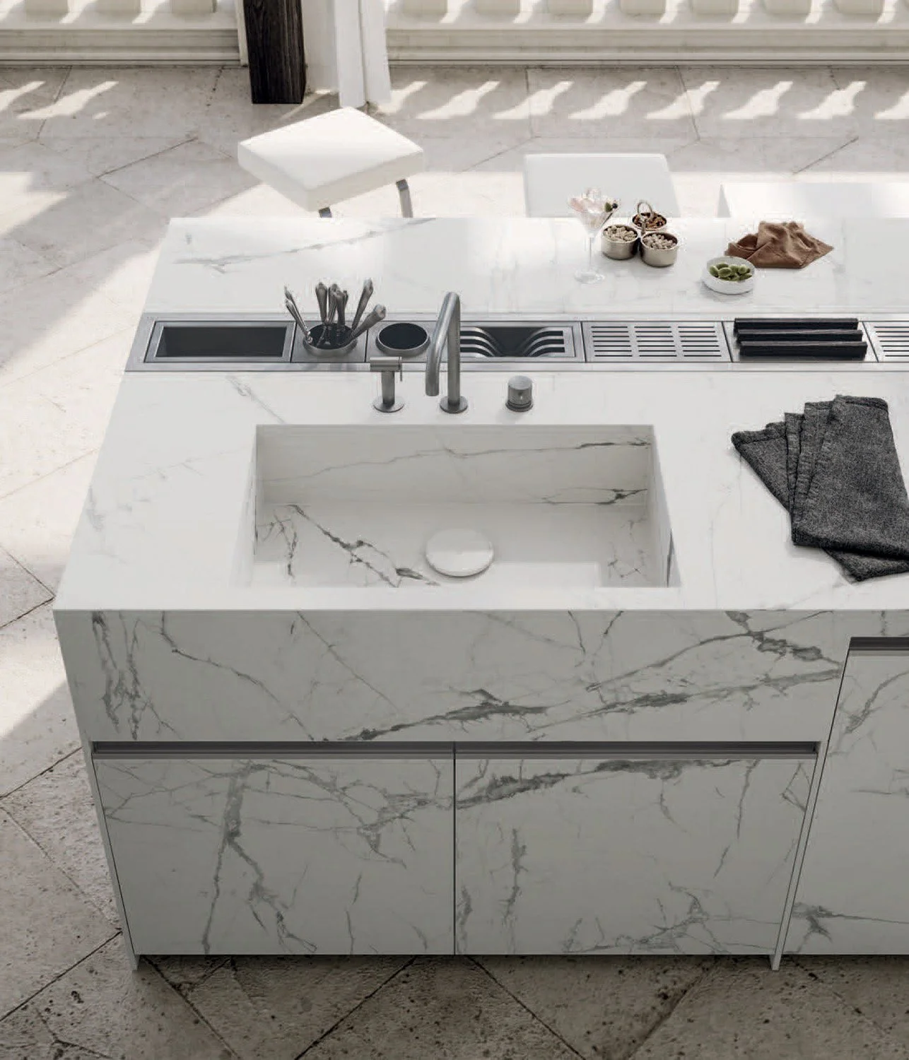 Close-up of precision-crafted steel cabinetry paired with porcelain work surfaces.