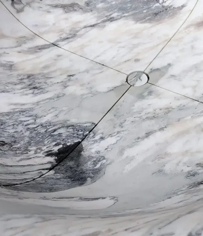 Vaselli marble bathtub in a modern bathroom, designed by Abitalia South Coast in Dorset, Hampshire, and Surrey.