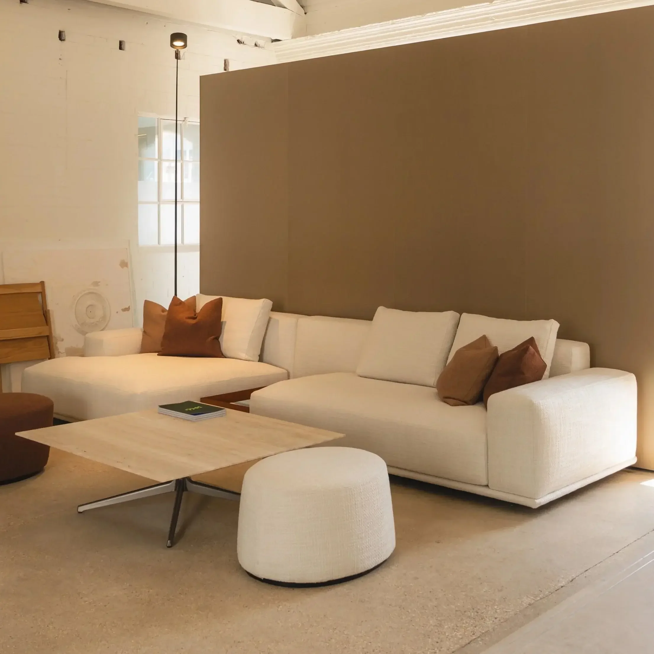 Designer sofa with white arms as part of a curated living room setup, perfect for luxury interiors, featured in our Poole, Dorset showroom