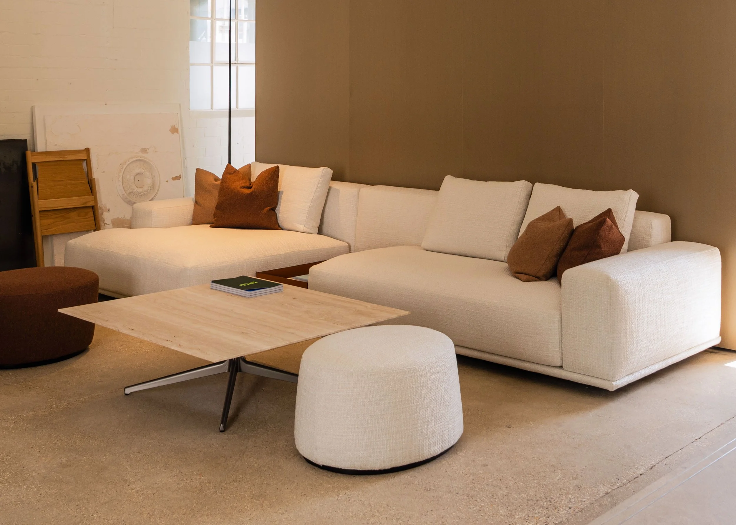 Designer sofa with white arms as part of a curated living room setup, perfect for luxury interiors, featured in our Poole, Dorset showroom