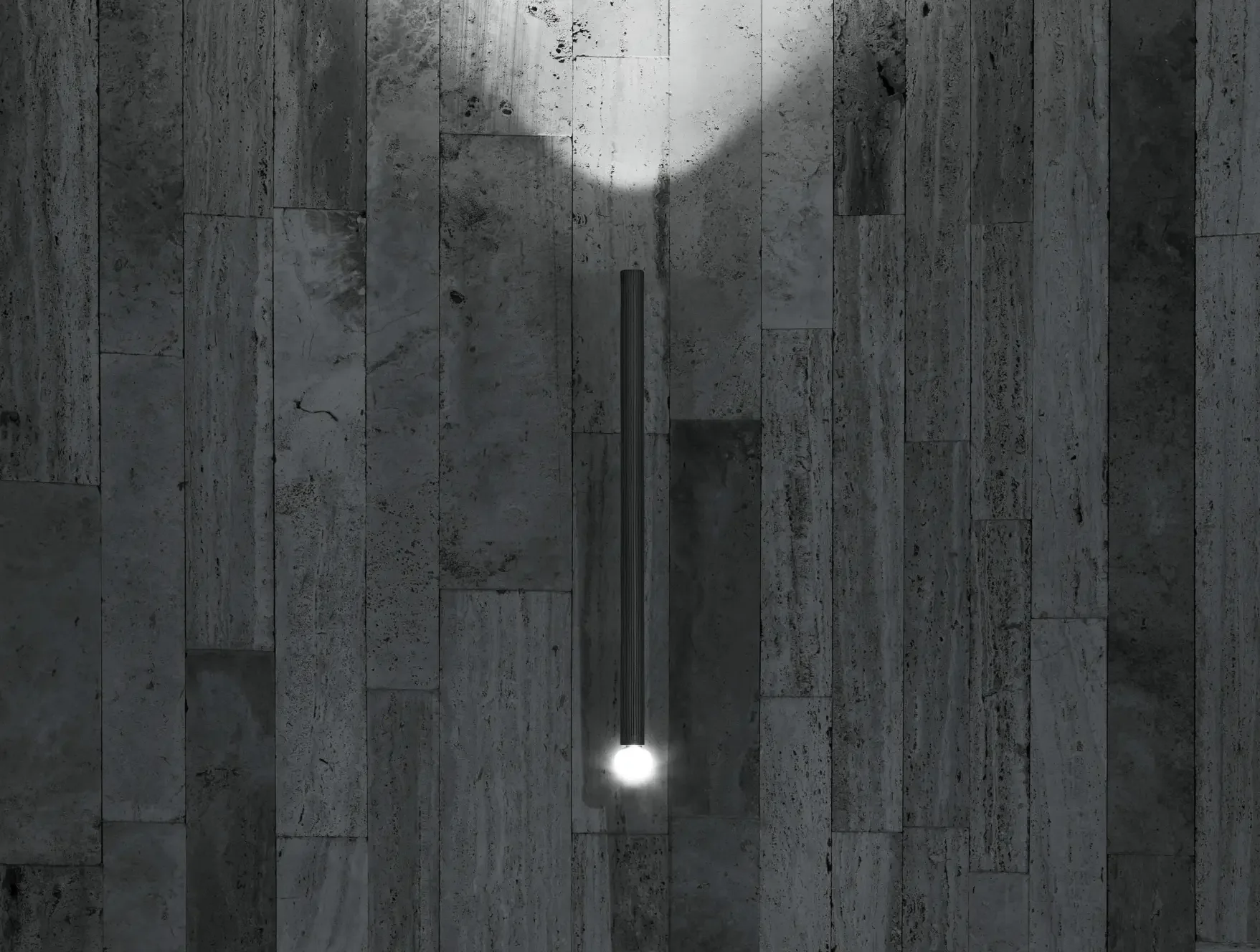 Flos outdoor wall light casting soft, ambient illumination on a terrace.