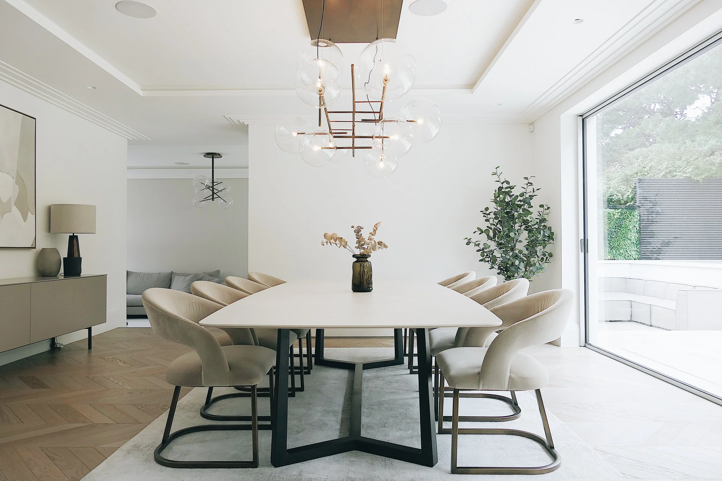 Dining room featuring modern lighting and dining table designed by Abitalia South Coast in Canford Cliffs.