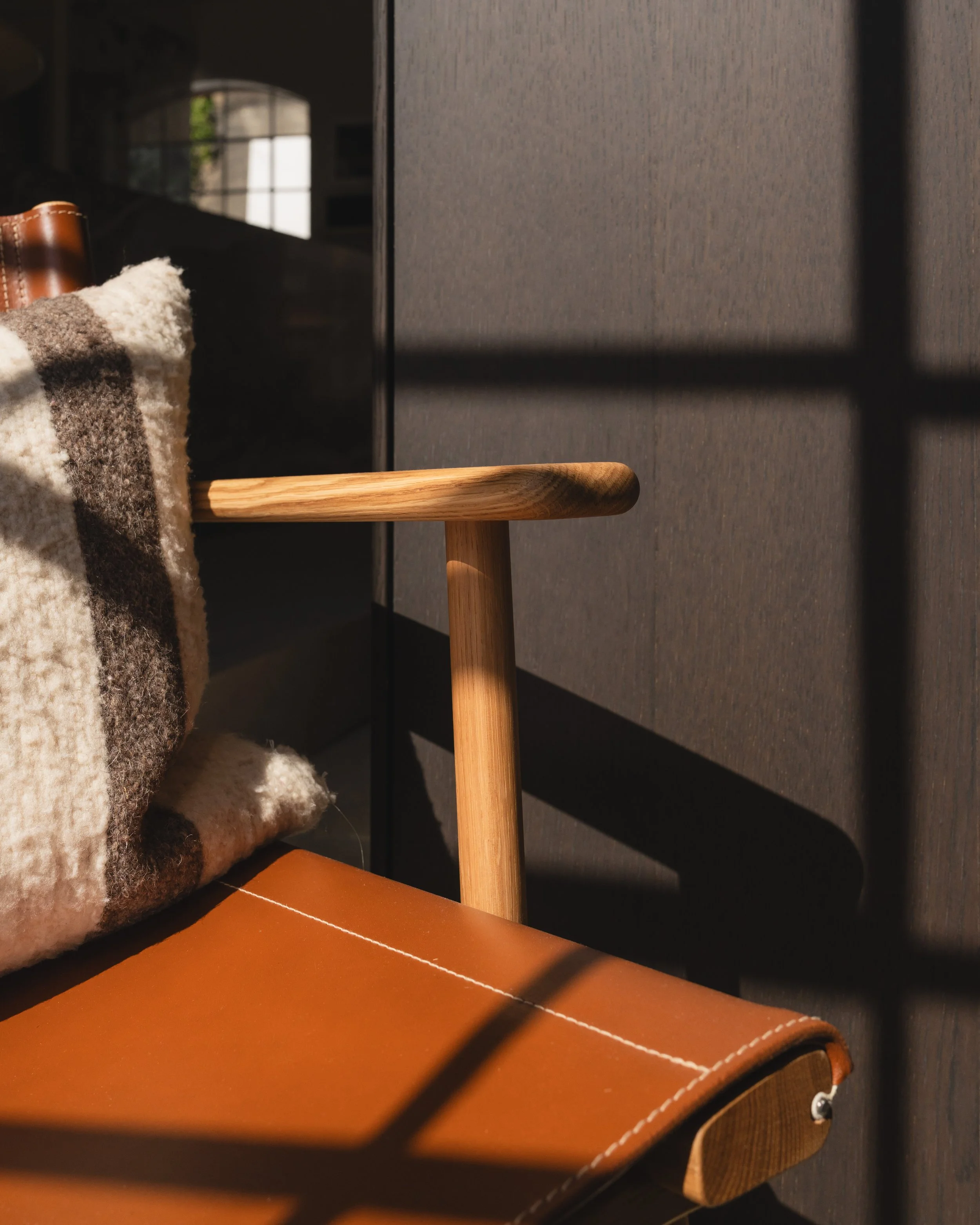 Detail of smooth wood frame and comfortable armrest on December by Nikari.
