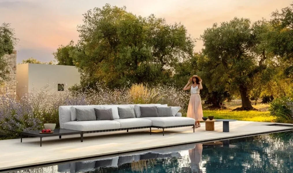 Salinas modular outdoor sofa by Talenti with plush cushions and natural Mediterranean-inspired tones in garden lounge setting.