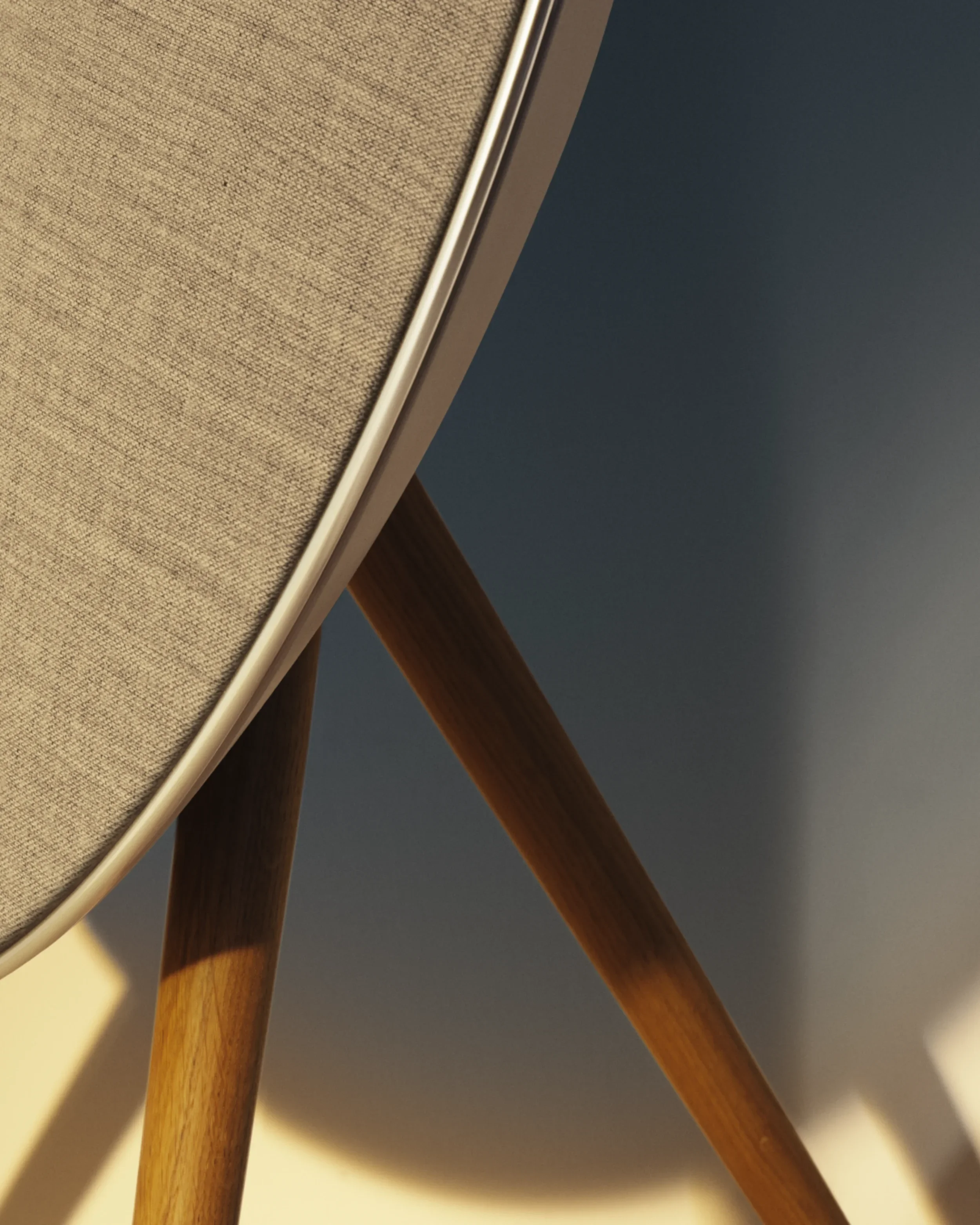 Close-up of Beosound A9 speaker showing precision-milled aluminium and fabric finish.