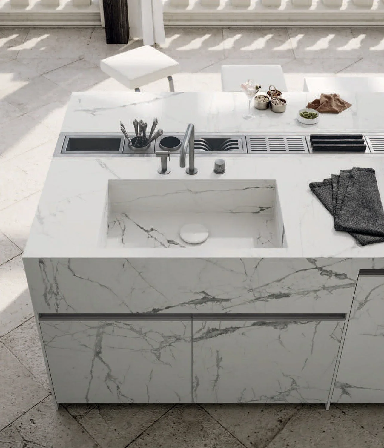 Close-up of precision-crafted steel cabinetry paired with porcelain work surfaces.