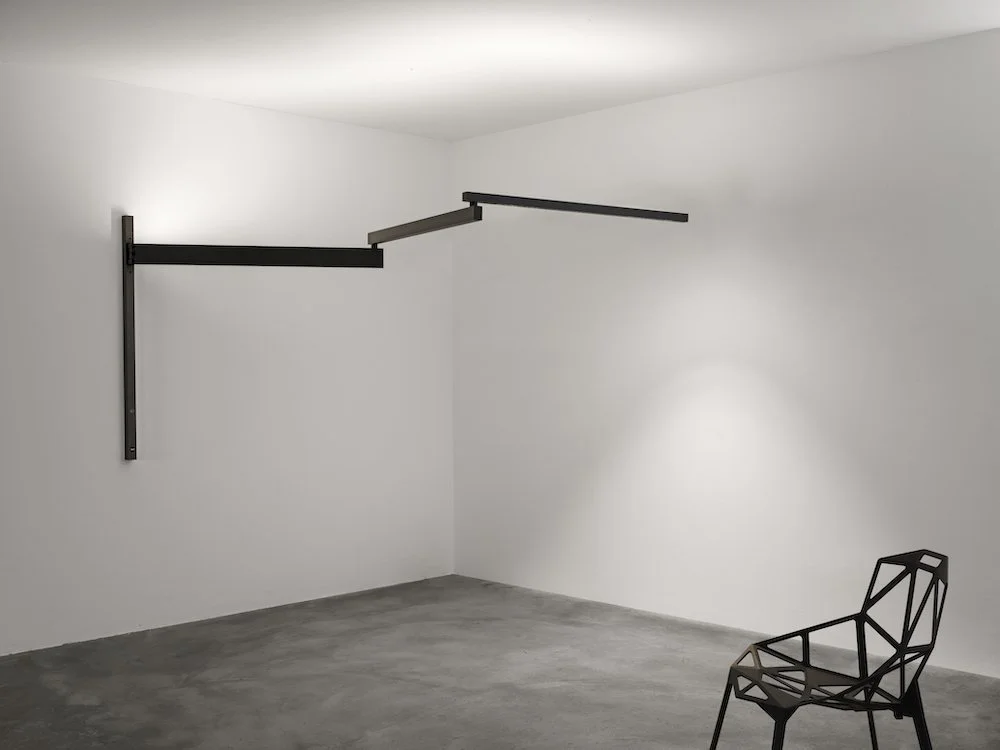 Modern wall lamp with an adjustable arm reaching up to 3.5 metres for flexible lighting.