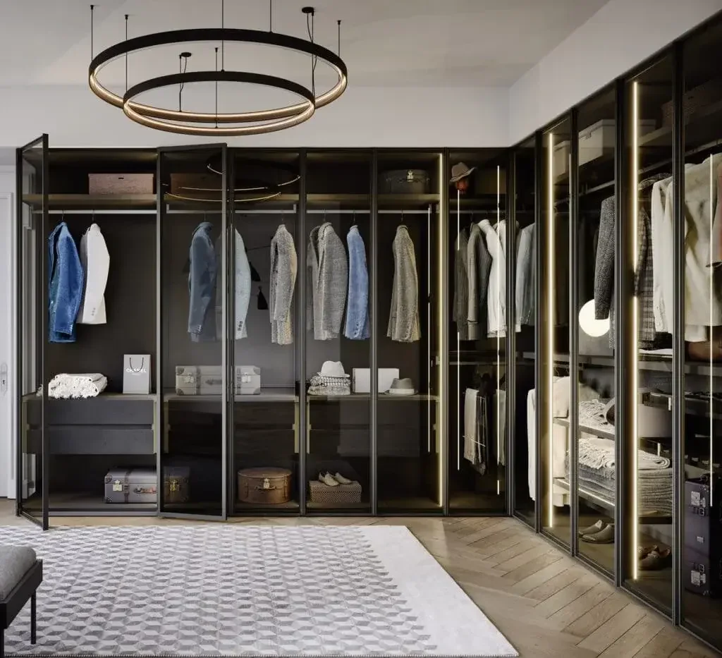 Perry wardrobe by Novamobili with oxidised bronze frame, smoked glass panels, and integrated LED lighting in modern interior.