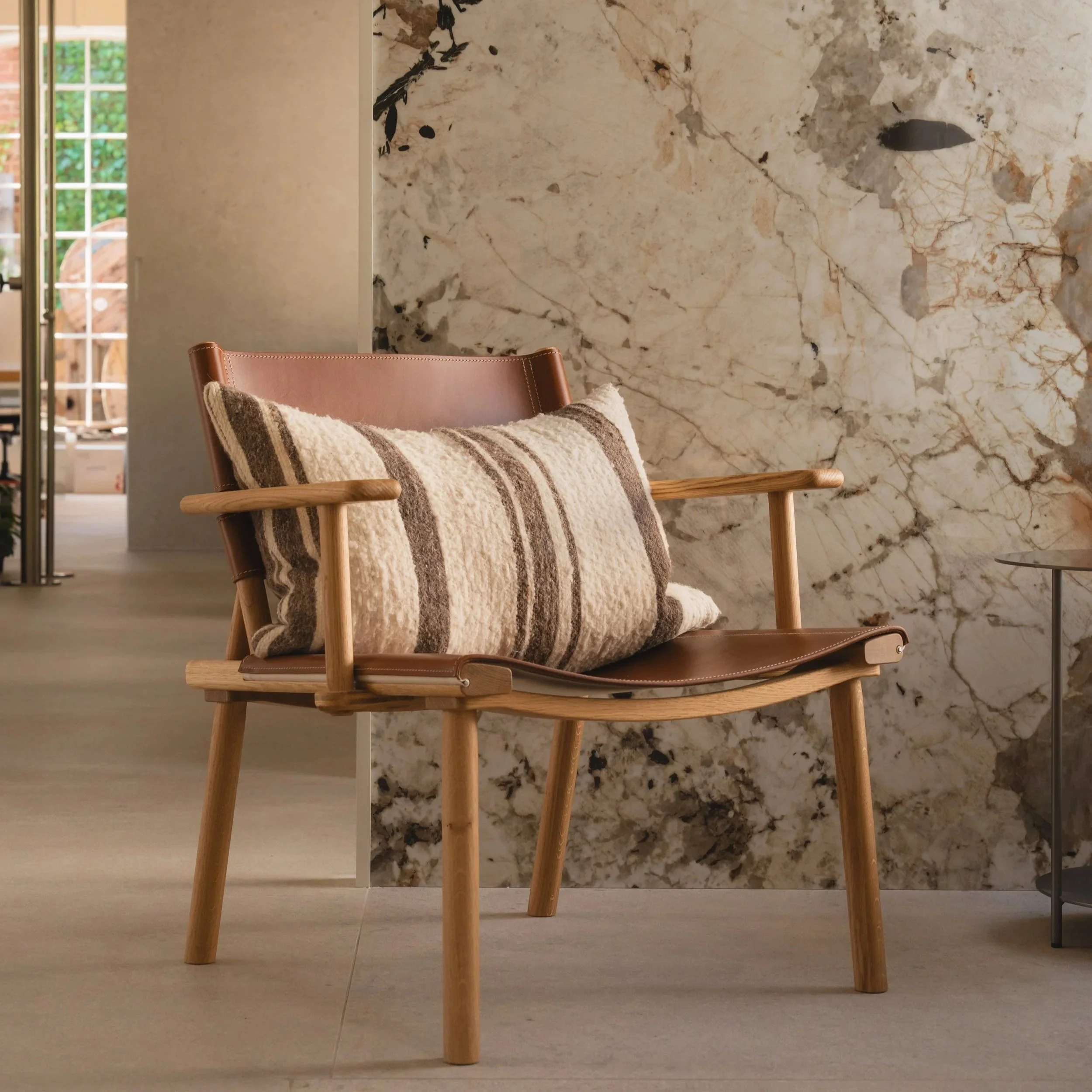 December Lounge Chair by Nikari in oiled ash with linen upholstery in a modern living room.