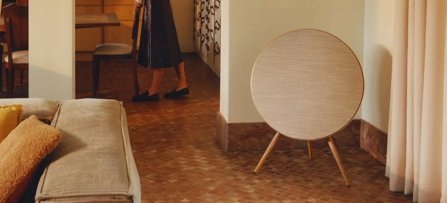 Beosound A9 5th Gen wireless speaker by Bang & Olufsen with oak legs and customizable fabric in contemporary living room.