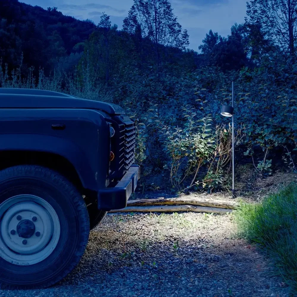 Davide Groppi Bubka Bollard outdoor floor lamp featuring an adjustable metal spotlight, AISI 316L stainless steel body, LED technology with 2700K or 3000K light, IP65 rated, supplied by Abitalia South Coast in Dorset, Hampshire, and Surrey.