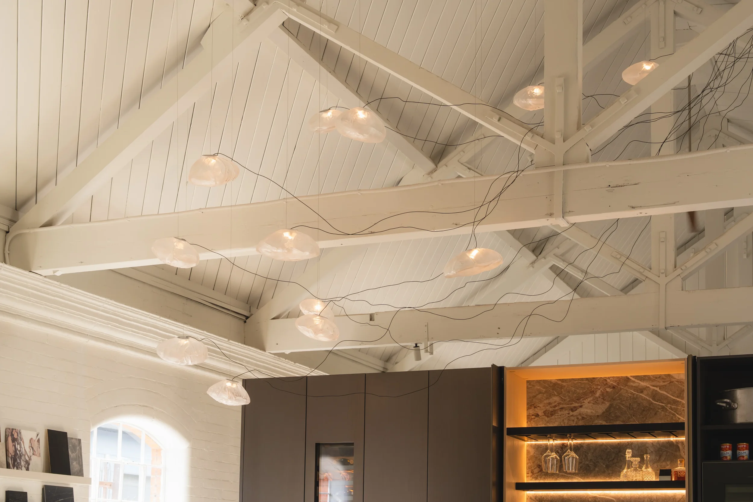 Designer pendant light creating atmospheric illumination and visual rhythm in a contemporary living environment.