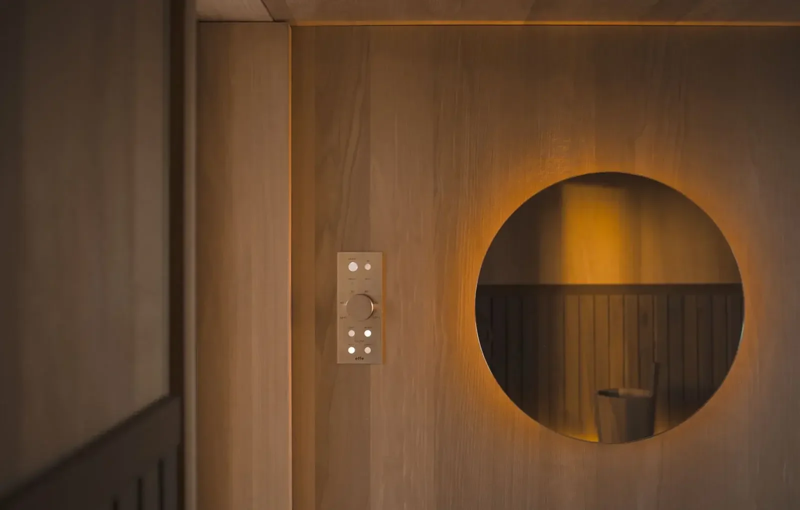 Effe Cabanon outdoor sauna designed by Rodolfo Dordoni, featuring heat-treated aspen wood, optional dark wood slats, corrugated aluminium cladding, and a dehumidifying stove, supplied by Abitalia South Coast in Dorset, Hampshire, and Surrey.