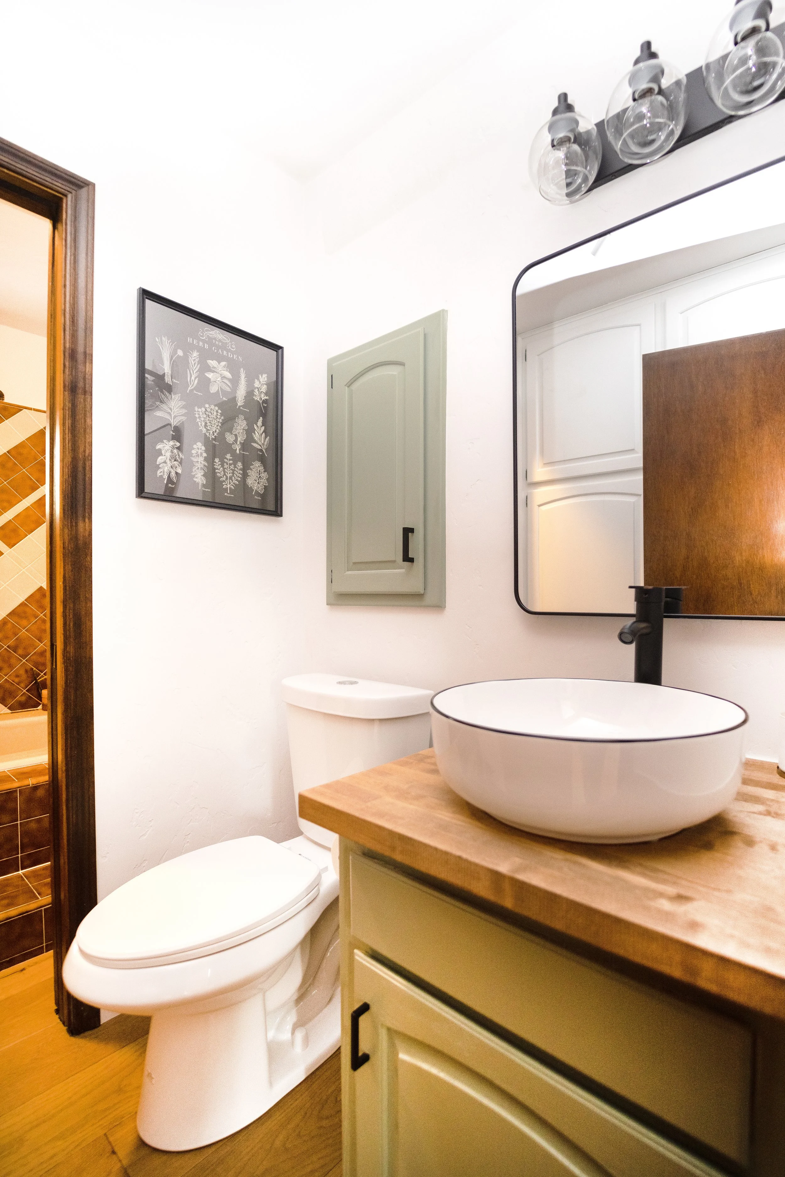 Bathroom cabinets were cleaned, primed, and painted.  New cabinet hardware installed, as well as engineered hardwood floors and a new toilet.  