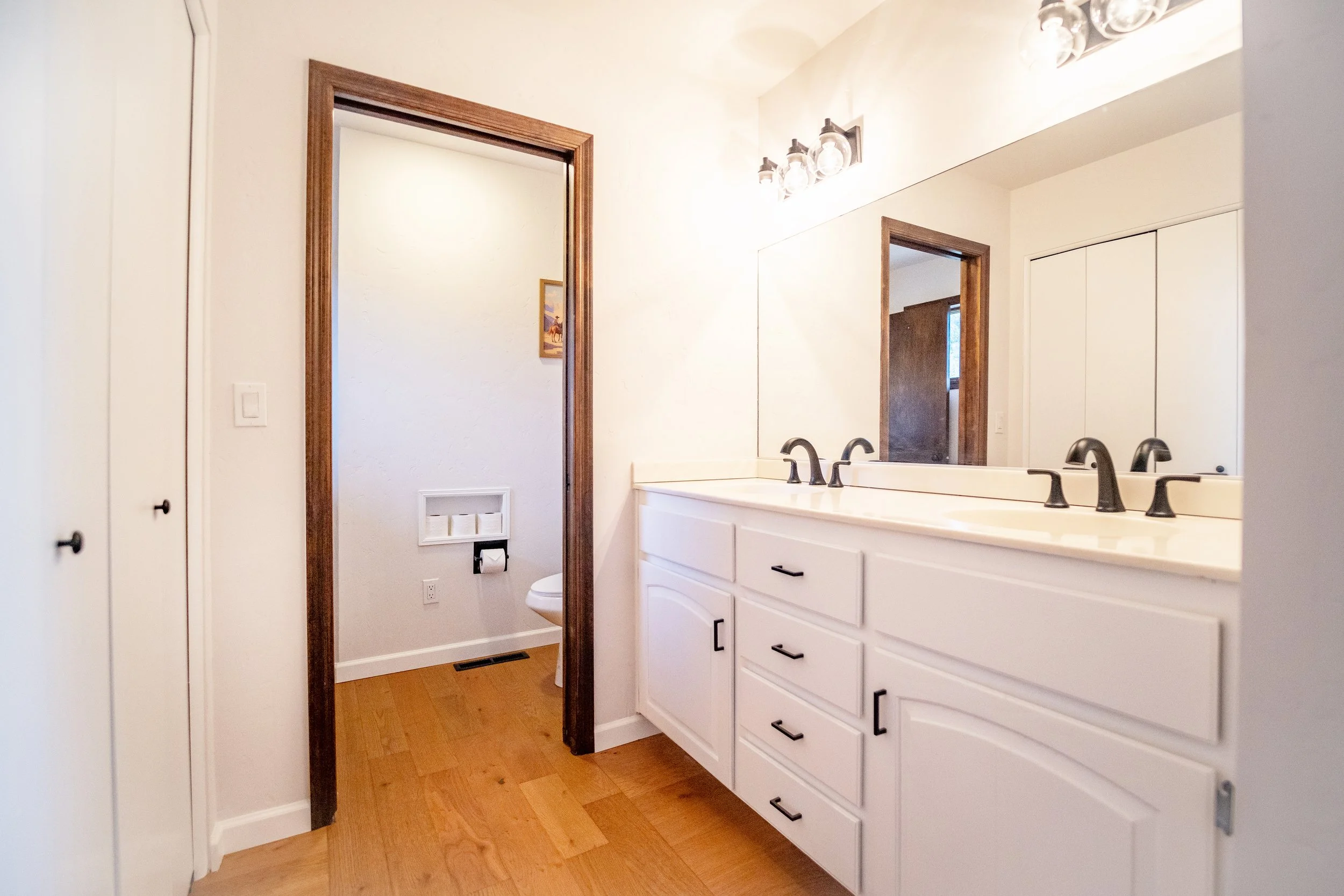 Bathroom cabinets were cleaned, primed, and painted.  New cabinet hardware installed, and a new toilet.  