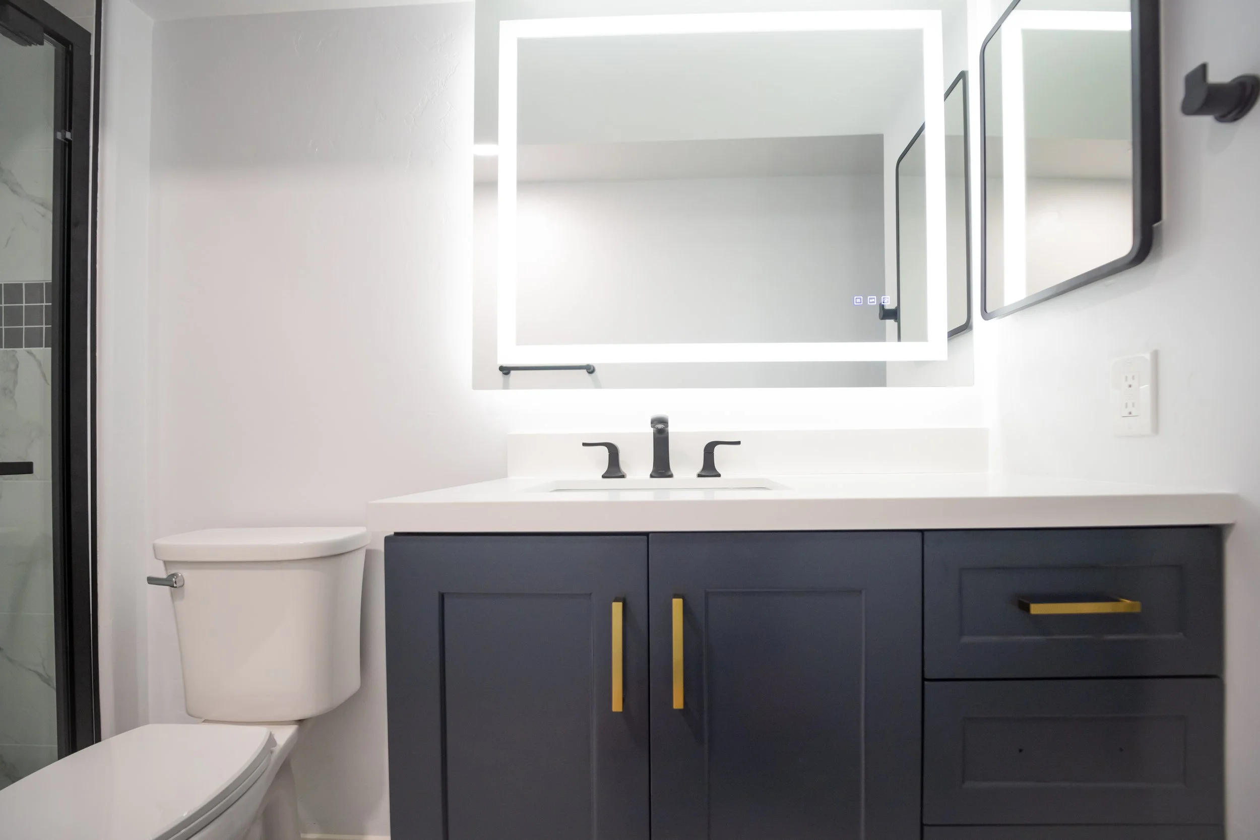 This floor to ceiling bathroom renovation includes shower tile and bathroom floor tile installation, new shower pan, shower door, shower fixtures and vent, light plumbing work and toilet installation, new bathroom cabinet and sink, as well as medicin