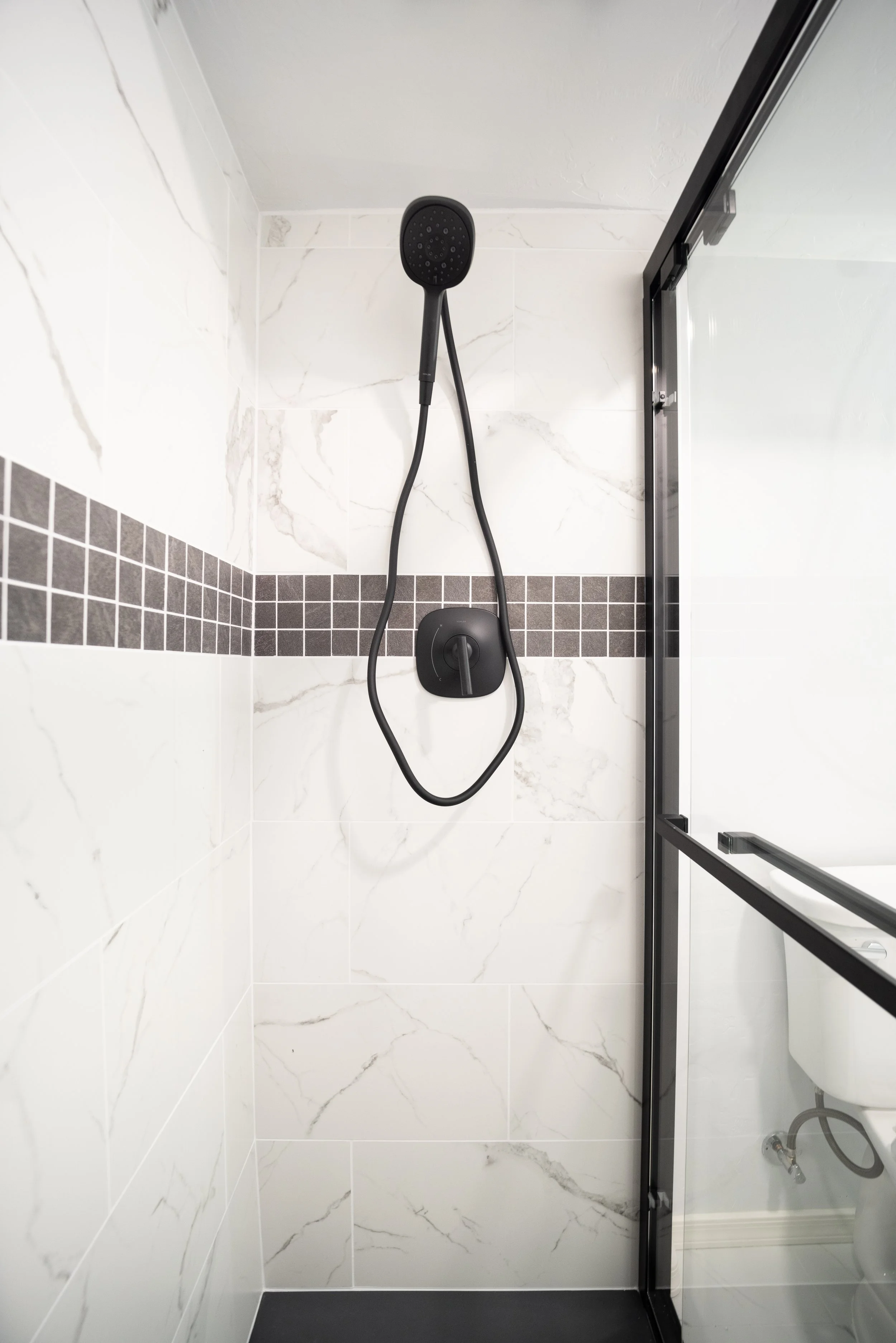 We worked closely with our client to bring their unique design tastes into a this bathroom remodel.  During the tile installation, our client expressed their desire for an accent strip to be added. We discussed together the best look and style for th
