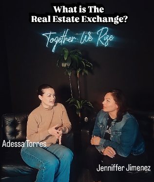 Two women sitting on a black leather couch in a dark room with a tall plant and neon sign that reads 'What is The Real Estate Exchange? Together we Rise.'