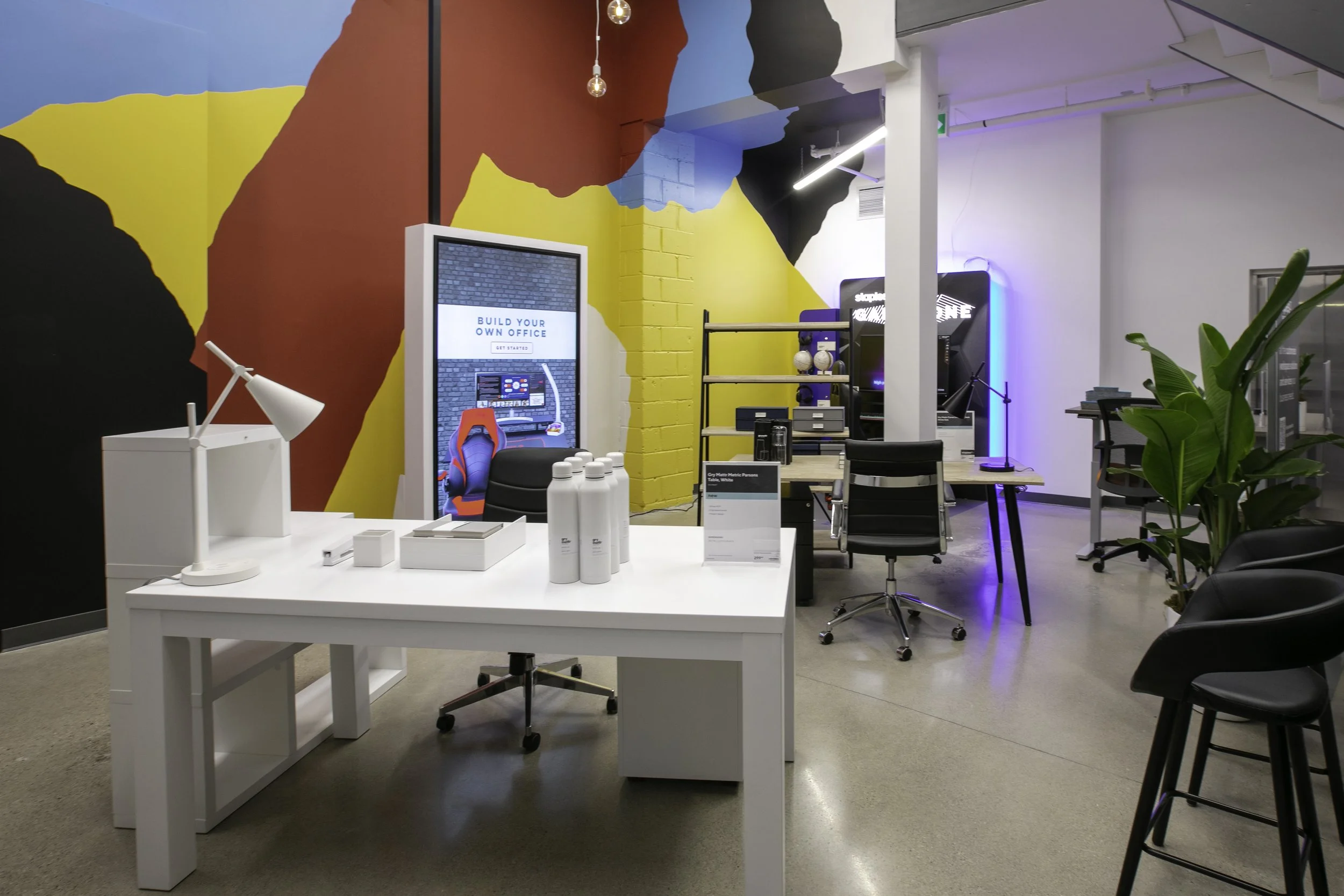 the workspaces department features a large mural installation and interactive furniture planning program. 