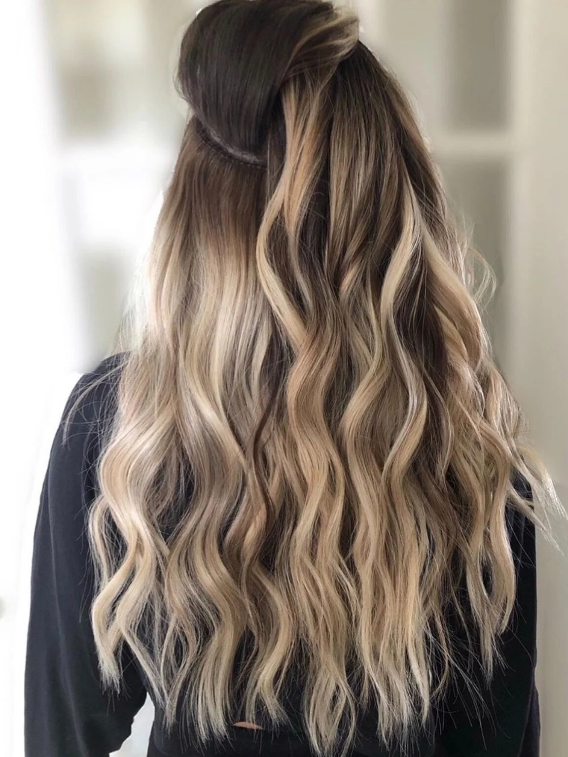 Long wavy blonde balayage with hair extensions