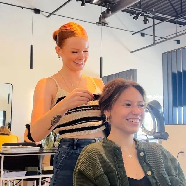 Stylist styling a client's hair in the salon