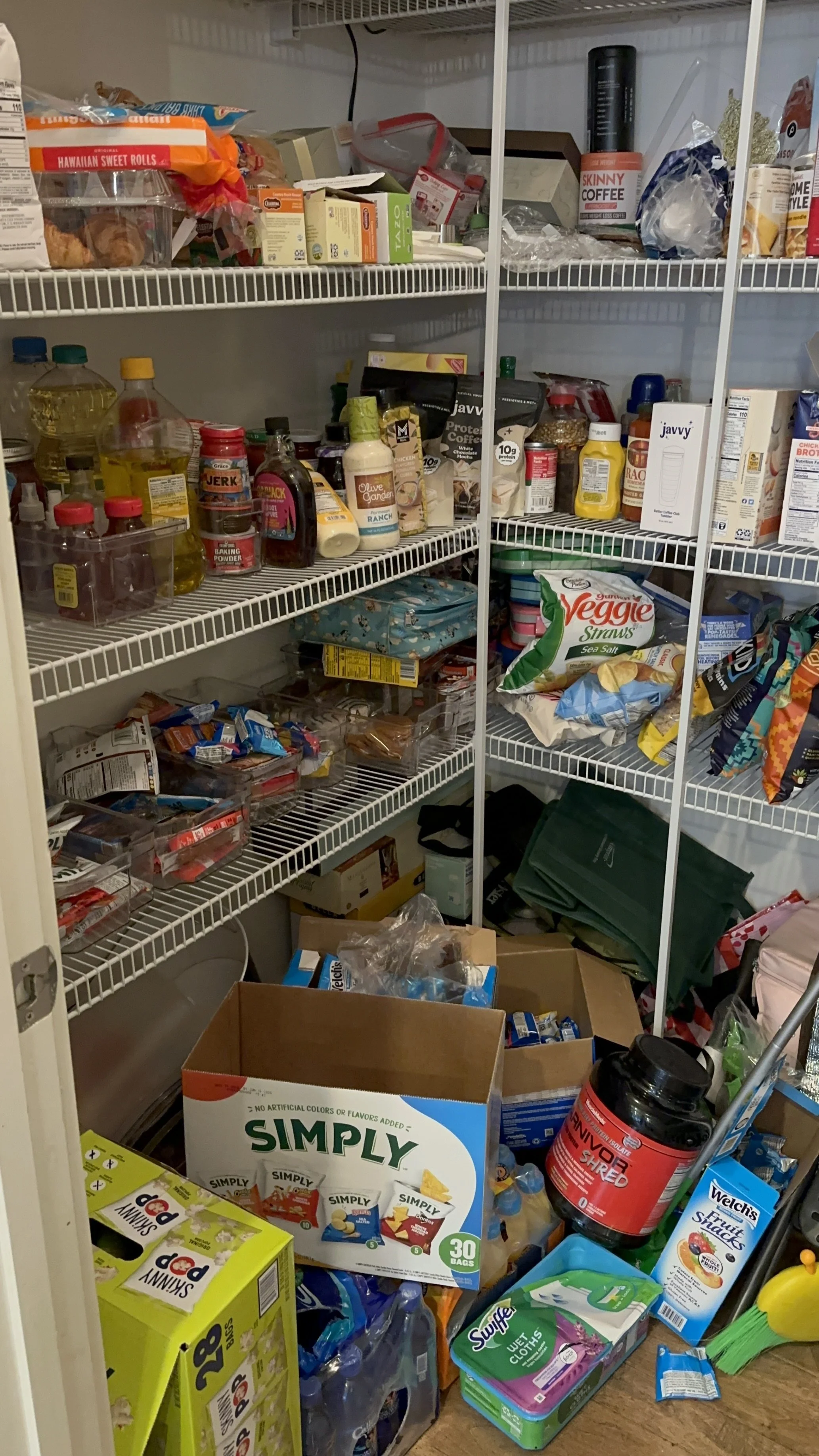 Cluttered pantry with disorganized shelves before professional organizing