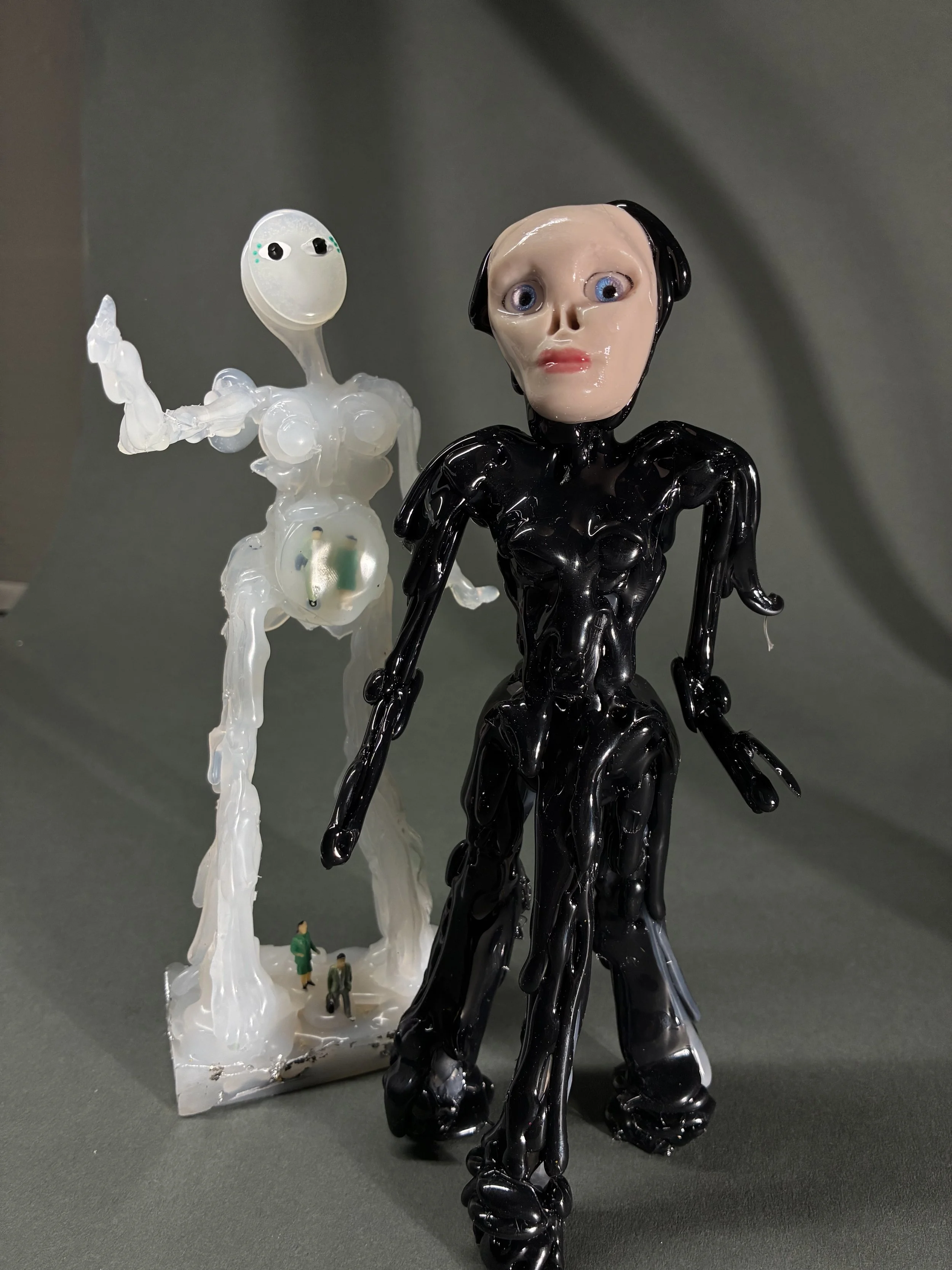 "Mother" and "Tula." 2026. Hot glue, polymer clay, resin.