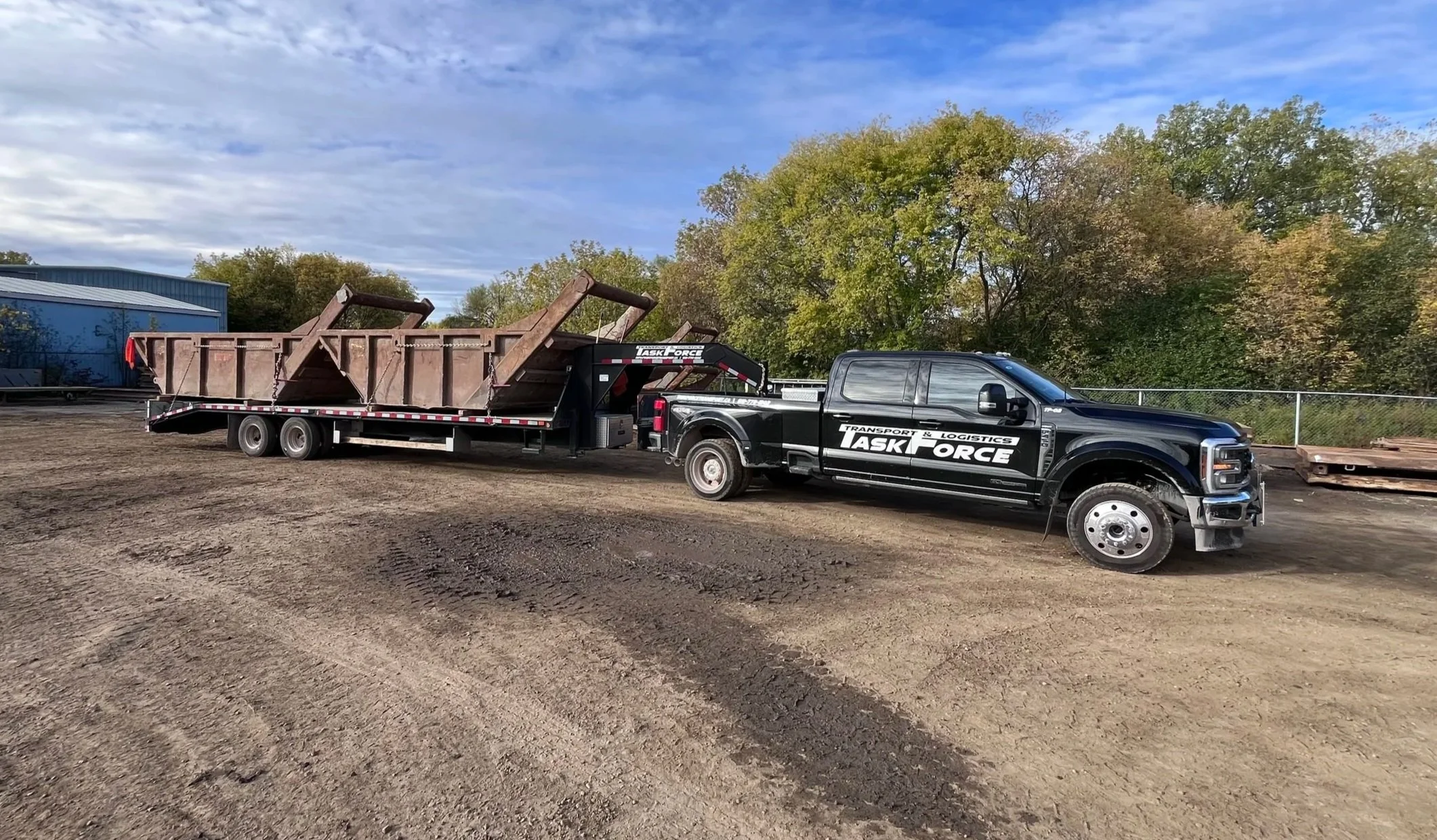 Task Force Transport & Logistics Ford F-450 hotshot truck transporting commercial cargo on a gooseneck flatbed trailer in Ontario, Canada.