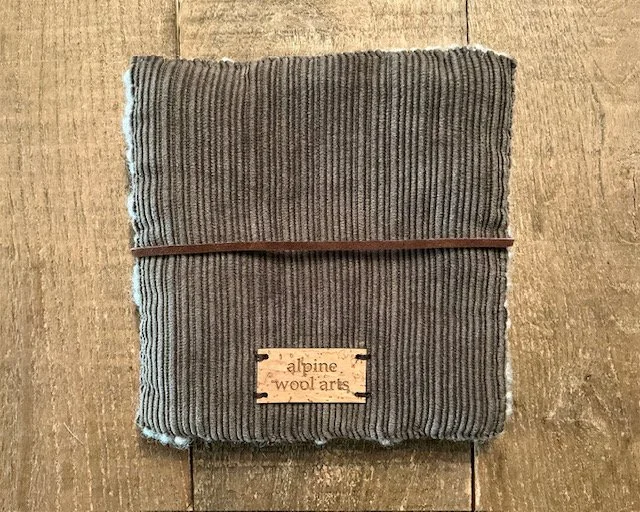 Back of hand-hooked wool panel in slate, showing finished cotton corduroy bakground.