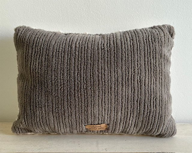 Back of pillow in gray cotton corduroy fabric.