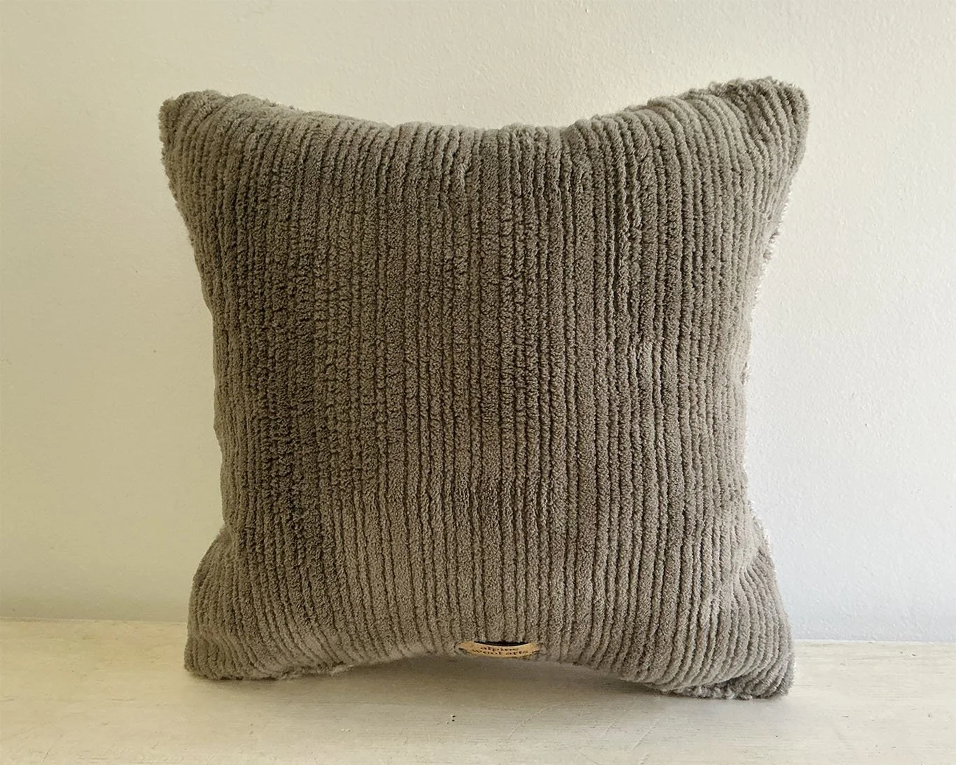 Back of pillow in slate cotton corduroy with vertical rib texture.