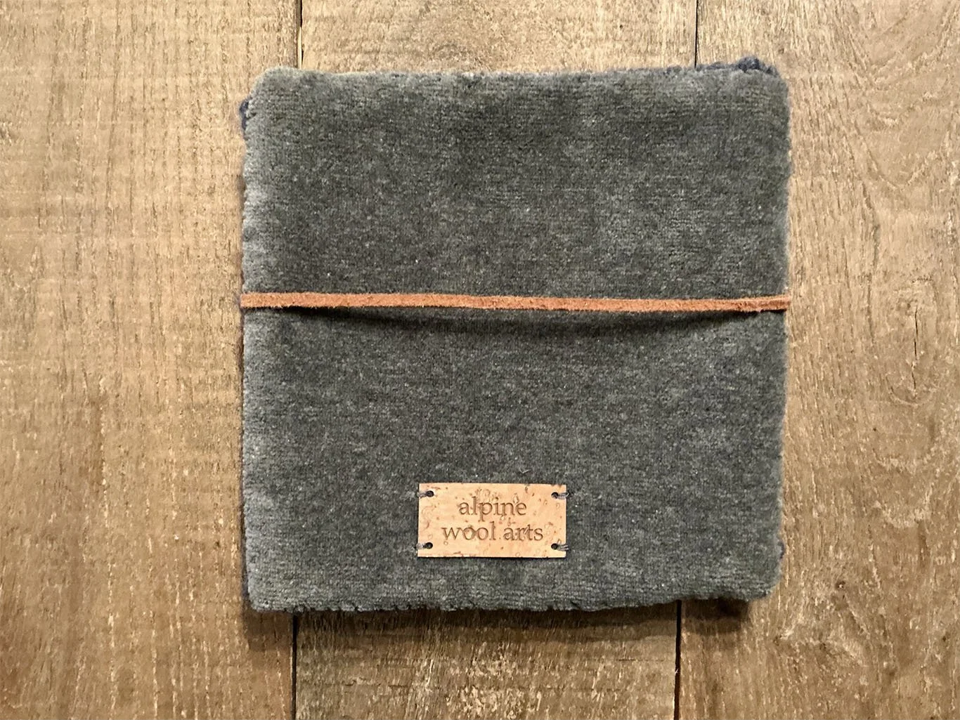 Back of hand-hooked wool panel in slate, showing finished textile backing.