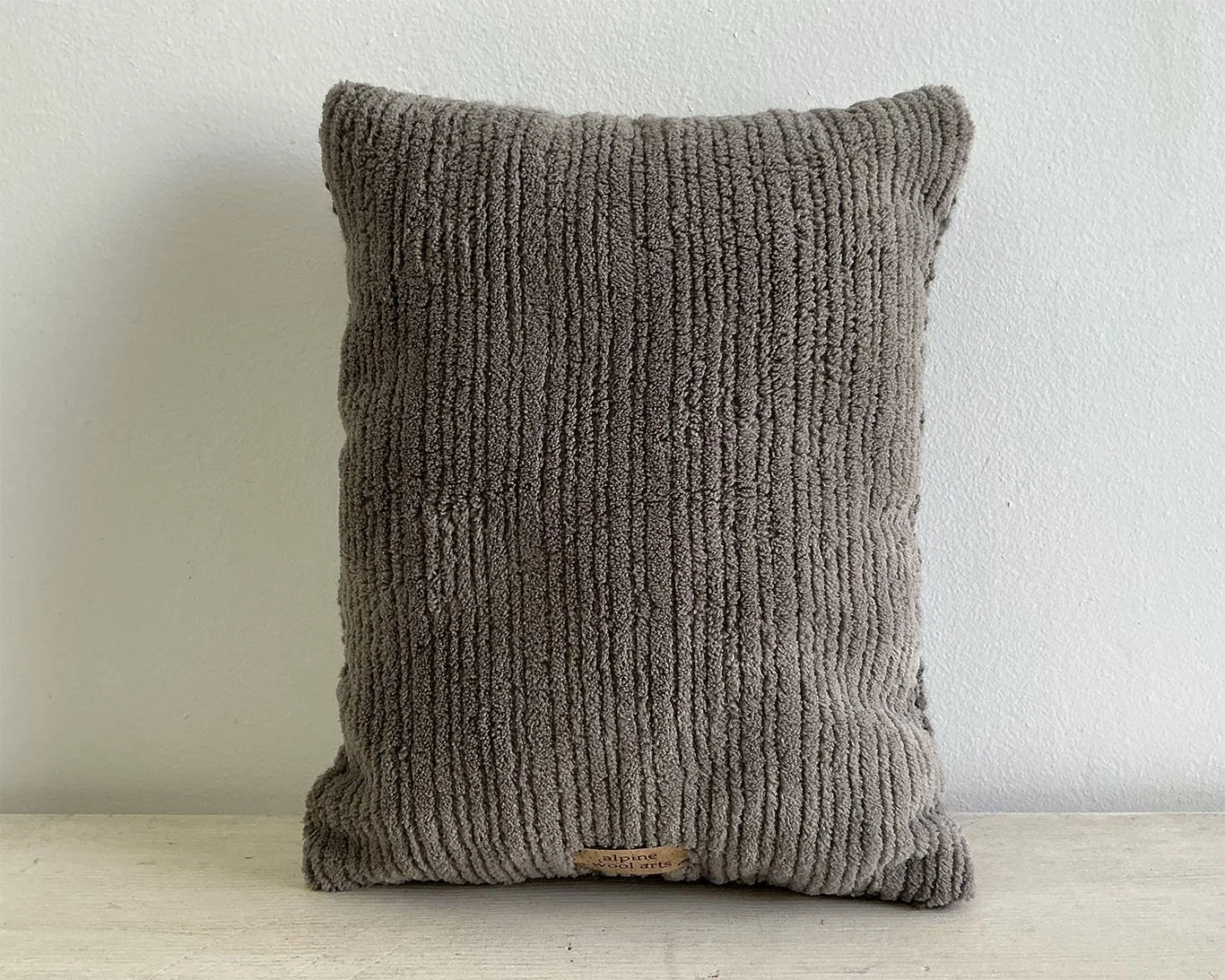 back of pillow in gray cotton corduroy fabric.