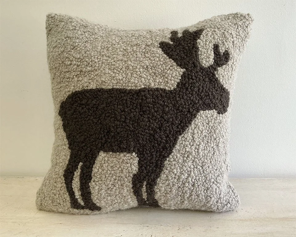 Natural hand-hooked wool pillow with a standing moose in dark brown.