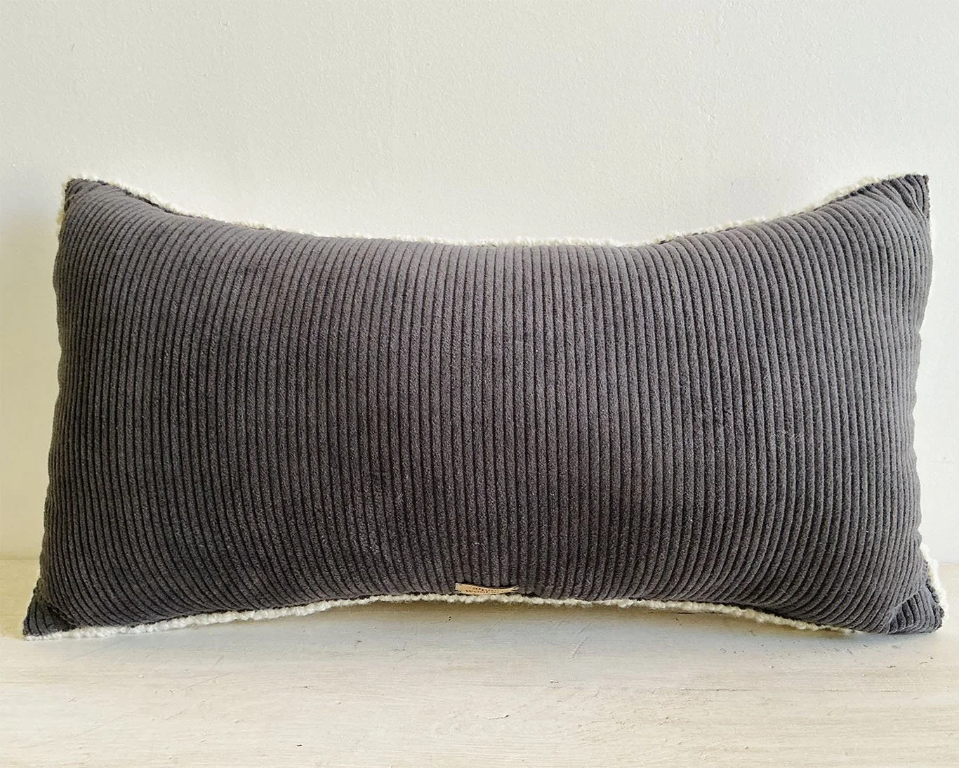 Back of wool pillow in slate cotton corduroy.