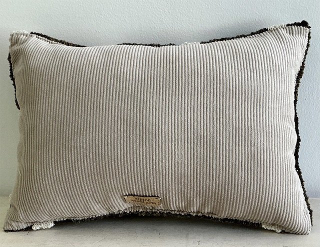 Back of pillow in natural cotton corduroy fabric.