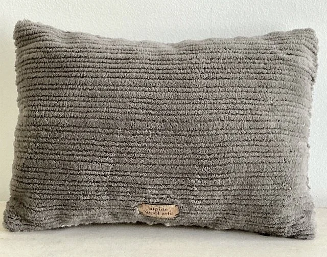 Back of pillow in gray cotton corduroy fabric.