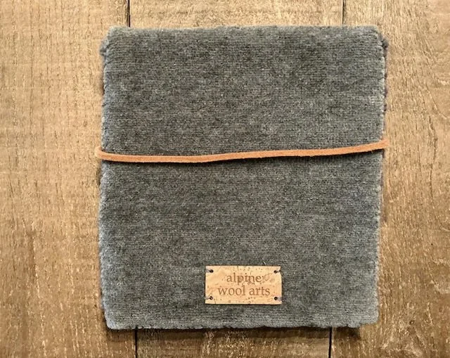 Back of hand-hooked wool panel in slate, showing finished textile backing.