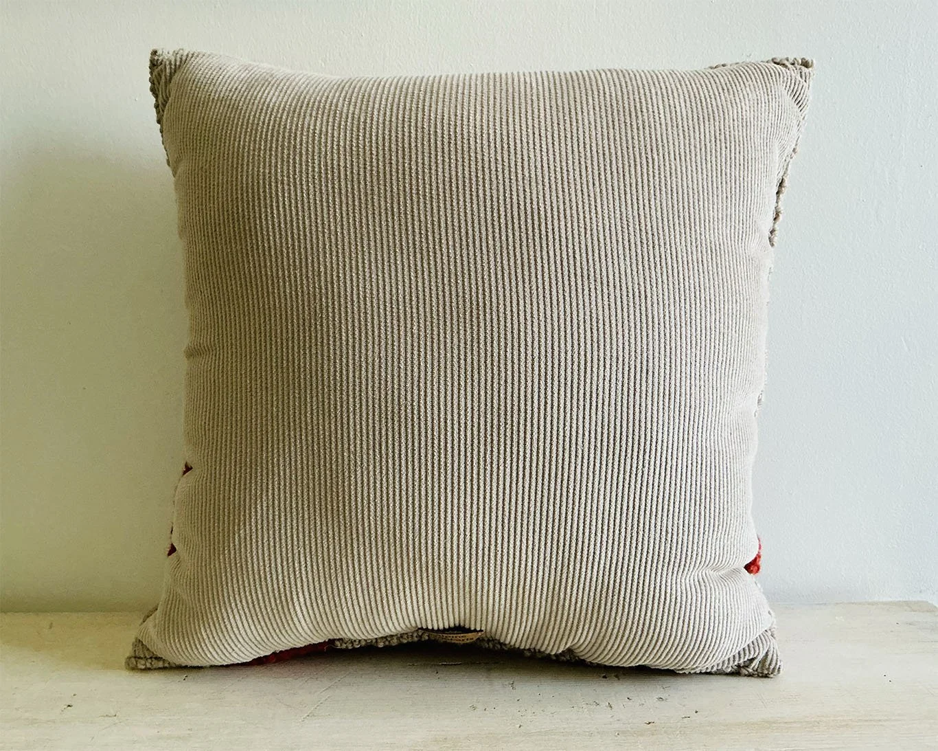 Back of pillow in natural cotton corduroy fabric.