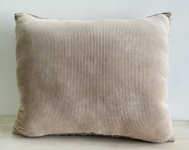 Back of pillow in tan cotton corduroy fabric.