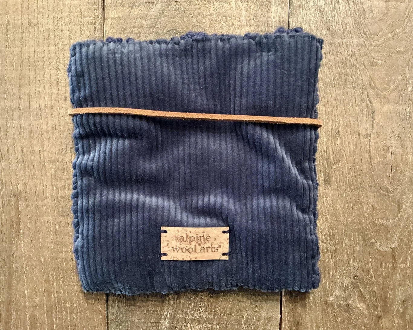 Back of hand-hooked wool panel in navy, showing finished cotton corduroy backing.