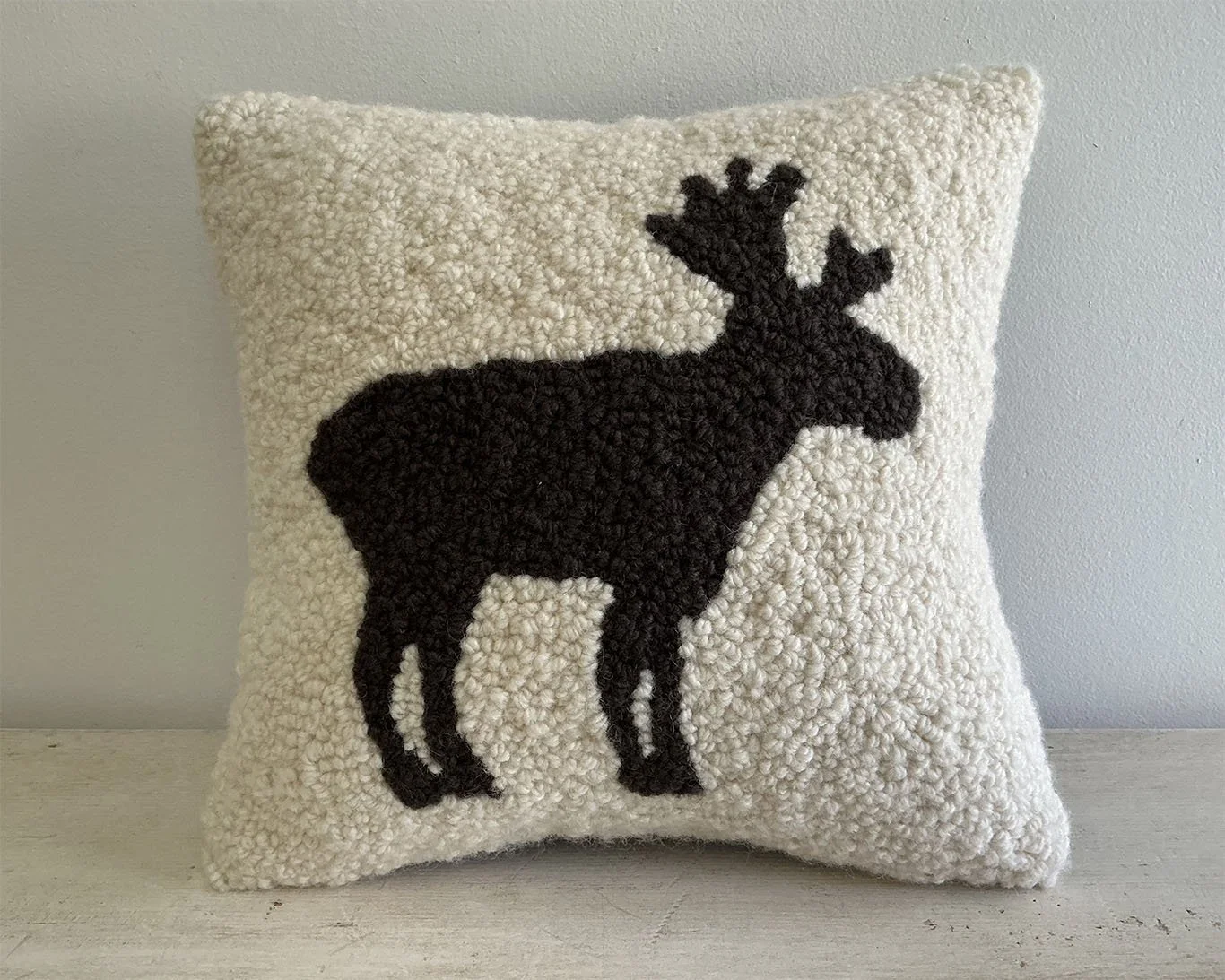 Ivory hand-hooked wool pillow with a standing moose.