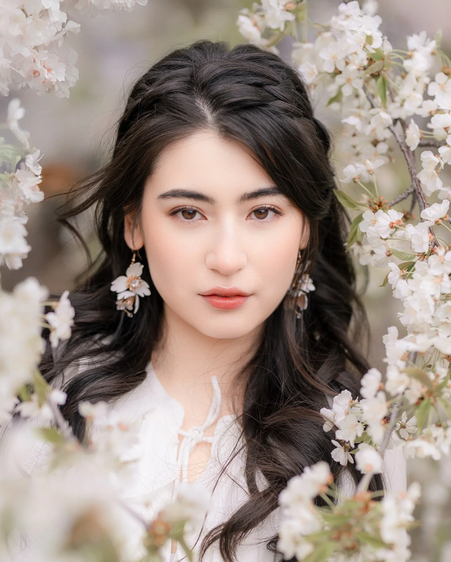 Toronto&rsquo;s white sakura has quietly bloomed, soft as snow.
She stands among the petals&mdash;serene and gentle&mdash;
like a portrait painted by spring itself.

Her dress sways with the breeze, blossoms resting on her shoulder,
and in her eyes, 