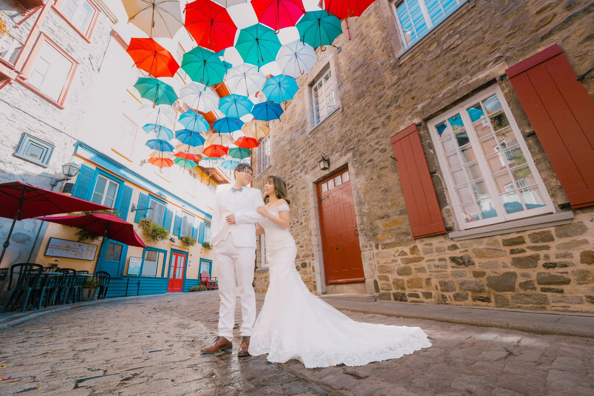   Couple under the colorful hanging umbrellas  