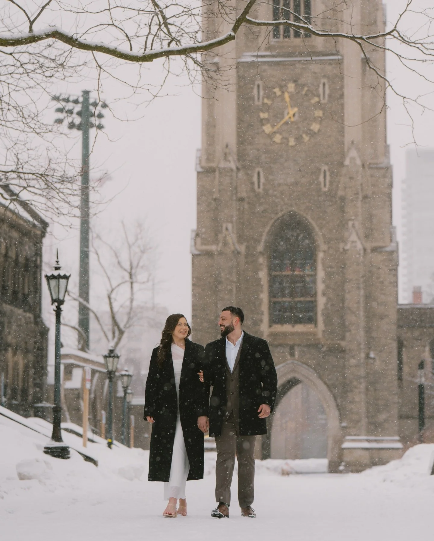 When the snow started falling during this engagement session at Hart House, I knew we were in for something truly special. The historic, gothic architecture of U of T covered in a fresh dusting of snow created the absolute perfect, cinematic backdrop