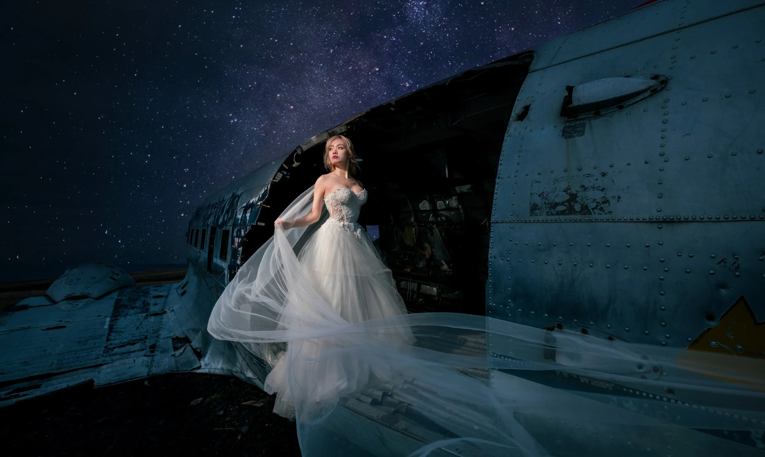 ride standing on the wing of the plane wreck at night