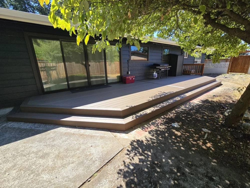 Edmonds low-level back deck replacement with TimberTech Dark Cocoa composite decking and wraparound steps