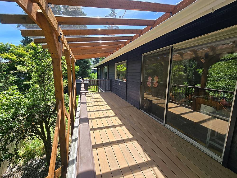 Covered composite deck with a clear polycarbonate roof letting in natural light